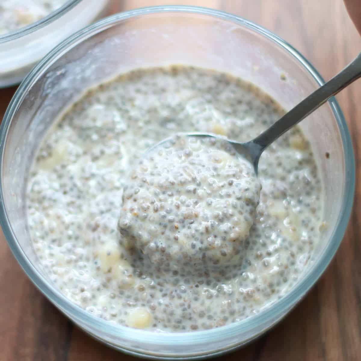 A close up shot of scooped banana chia pudding in a glass bowl.