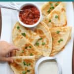 Quesadilla slices with salsa and ranch.