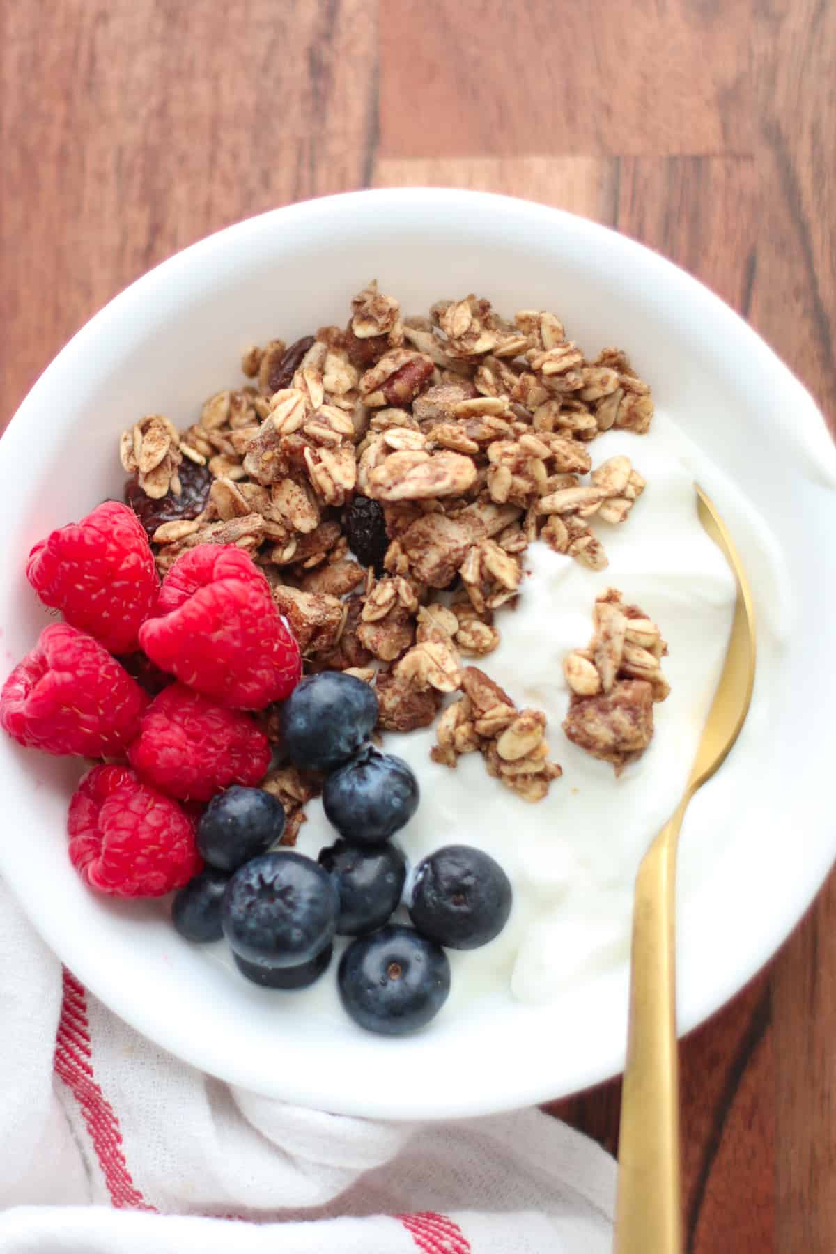 Yogurt topped with raspberries, blueberries, granola.