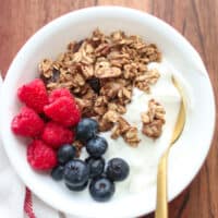 Yogurt topped with raspberries, blueberries, granola.