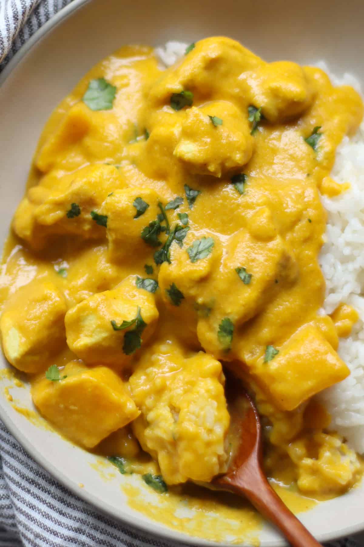 The finished dish of chicken mango curry served on a bed of rice.
