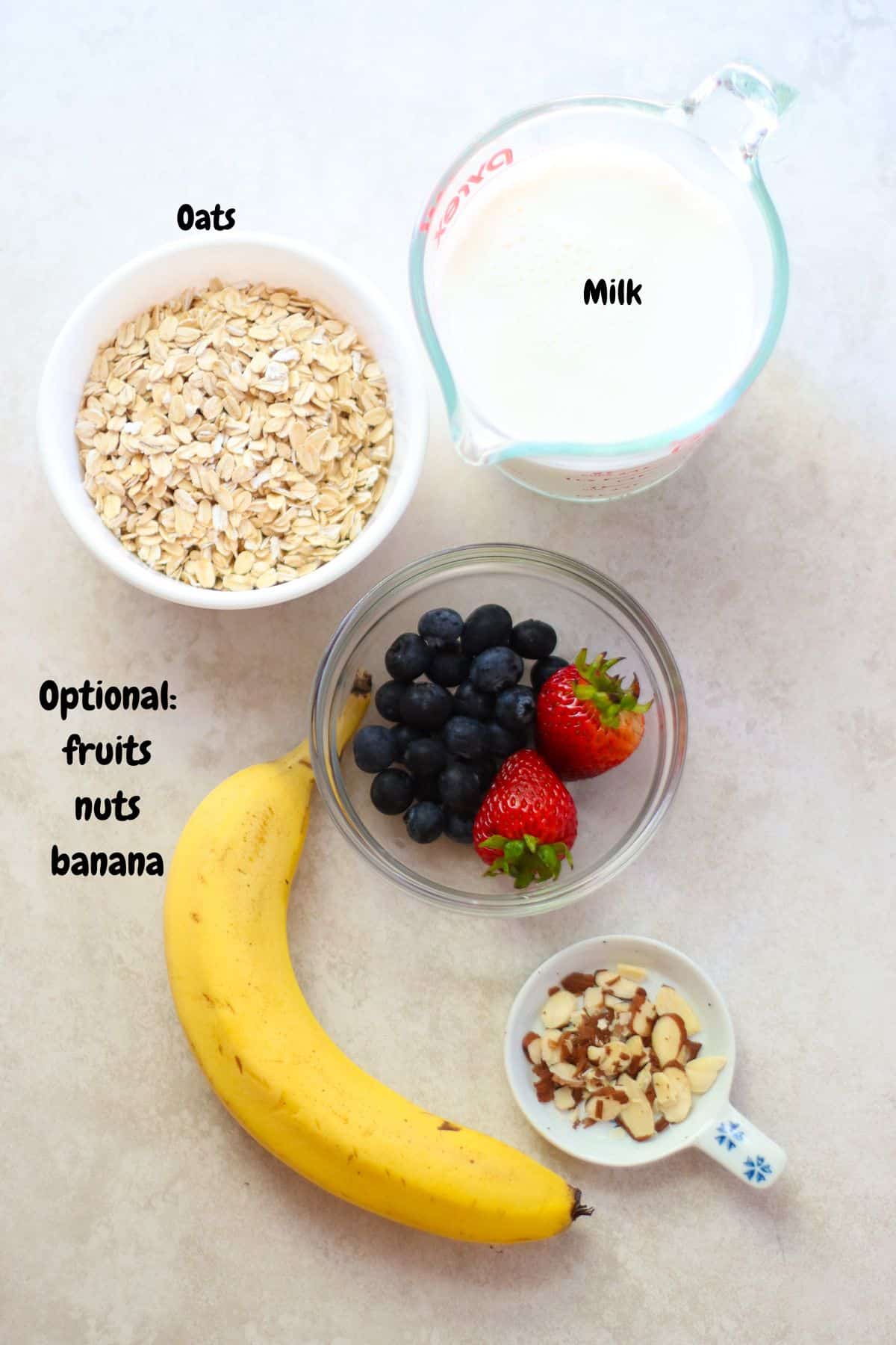 oats, milk, banana, fruits, and sliced almonds.