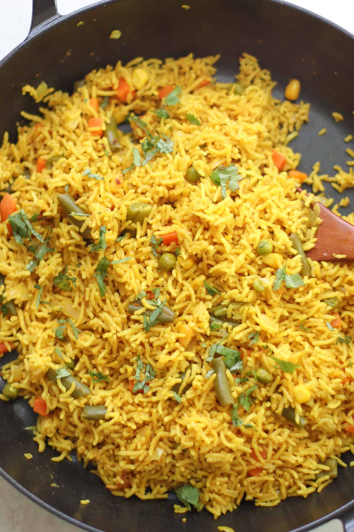 An overhead shot of cooked rice in large pan.