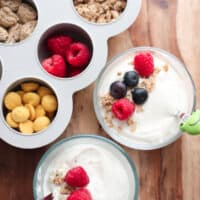 A close up shot of vanilla yogurt with berries and granola.