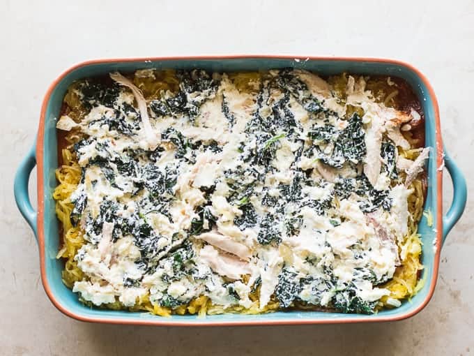 Kale ricotta mixture spread on top of the squash in casserole dish.