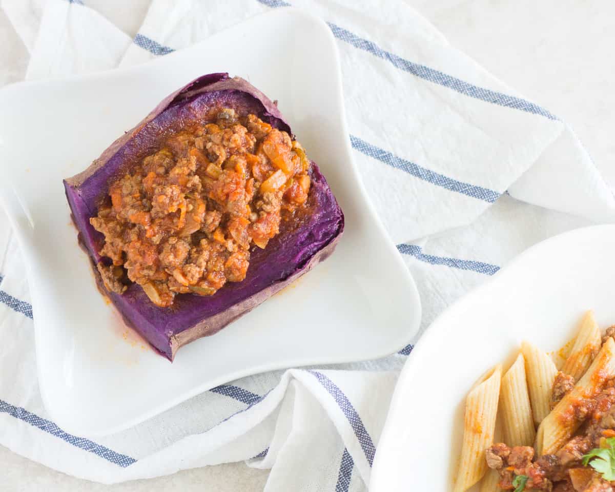 Bolognese served over cooked purple sweet potato.