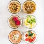 Six variations of overnight quinoa in mason jars.