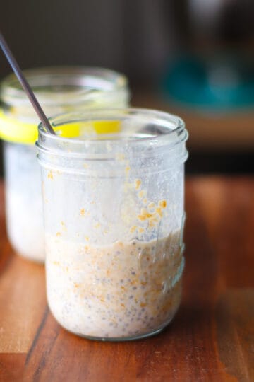 Overnight oats after soaking overnight in mason jar with a spoon.