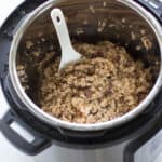 cooked rice inside the Instant pot with a spatula
