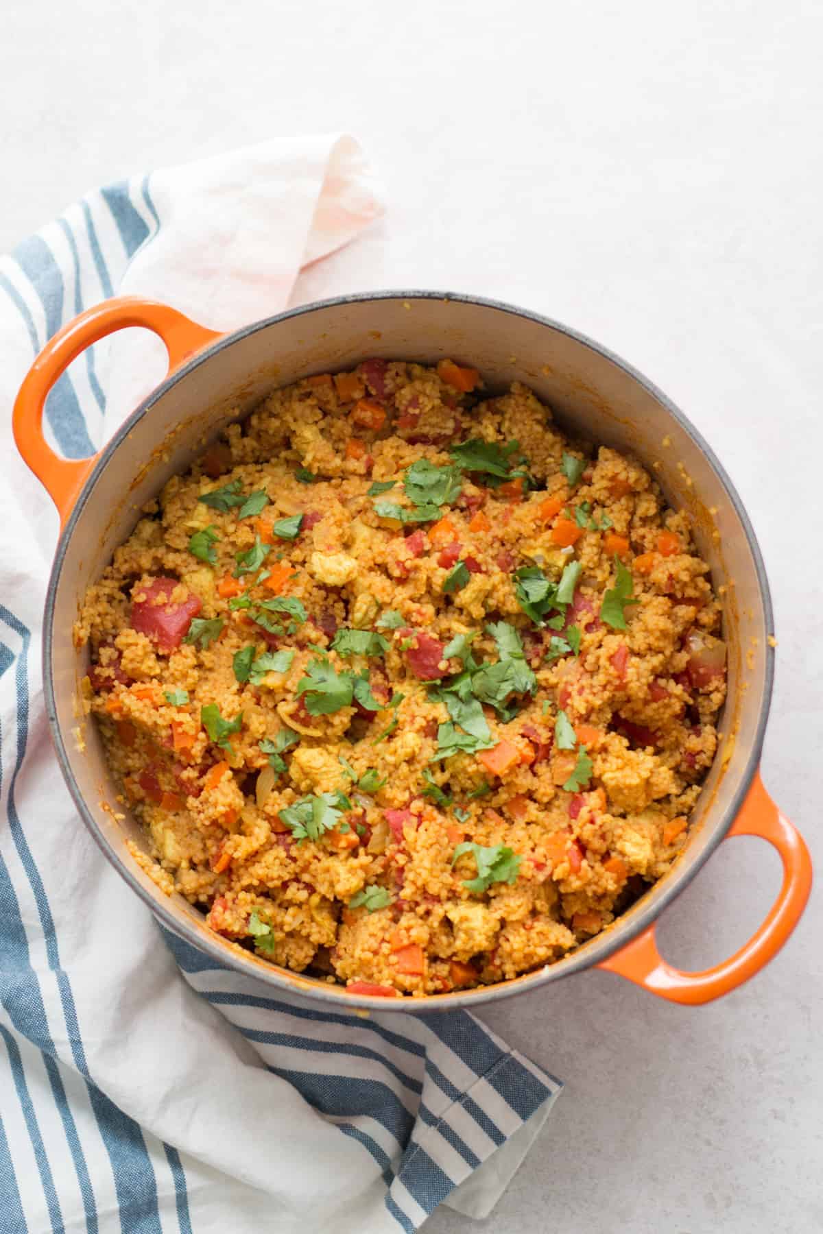 cooked couscous with fresh cilantro in a large oven Dutch oven