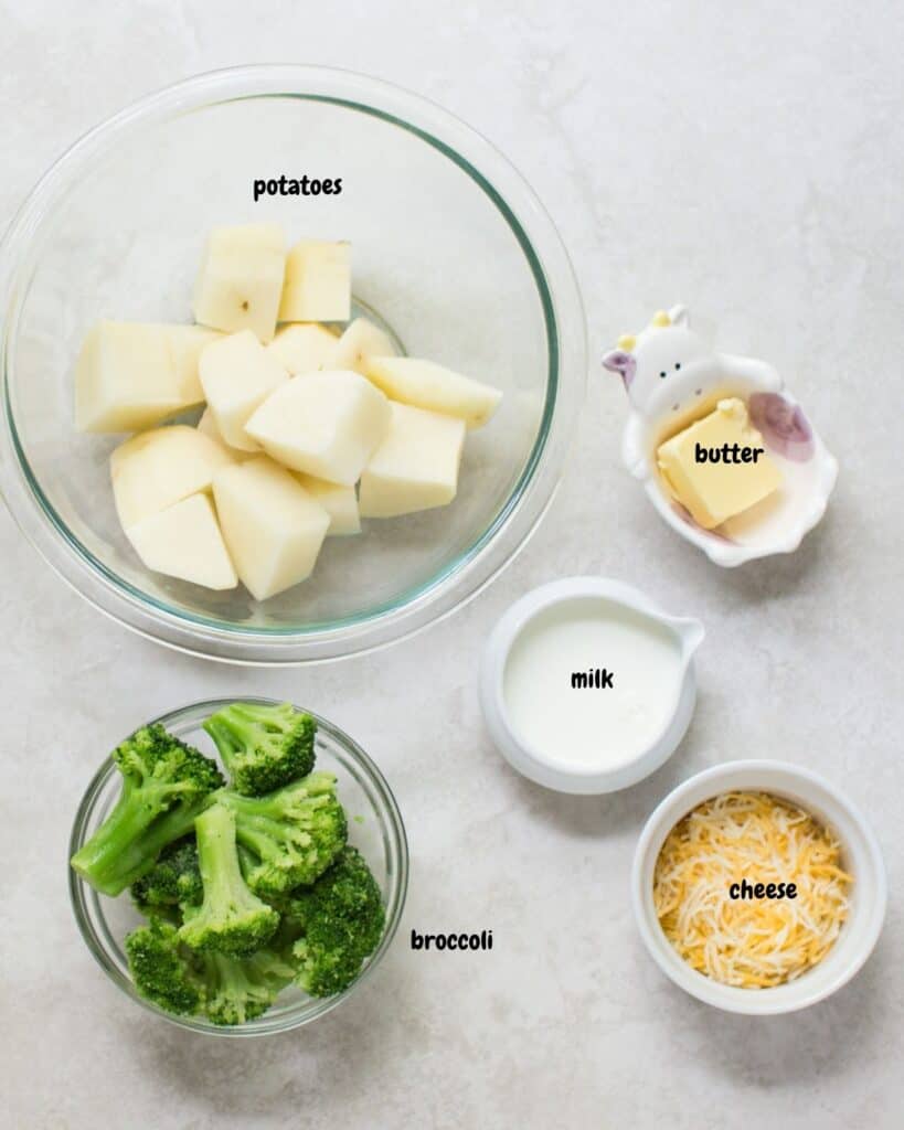 ingredients to make broccoli mashed potatoes on a white background