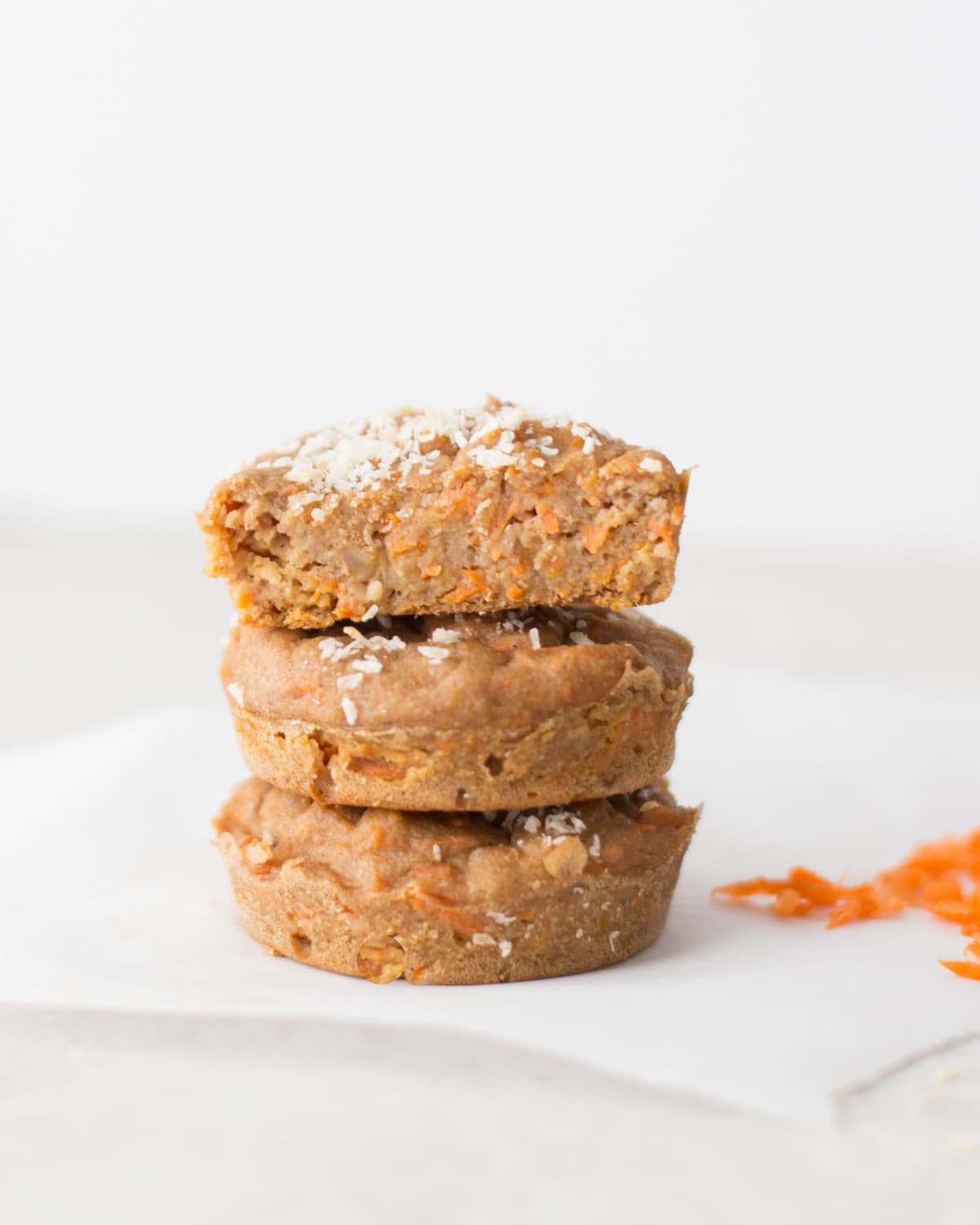 Three carrot muffins stacked.