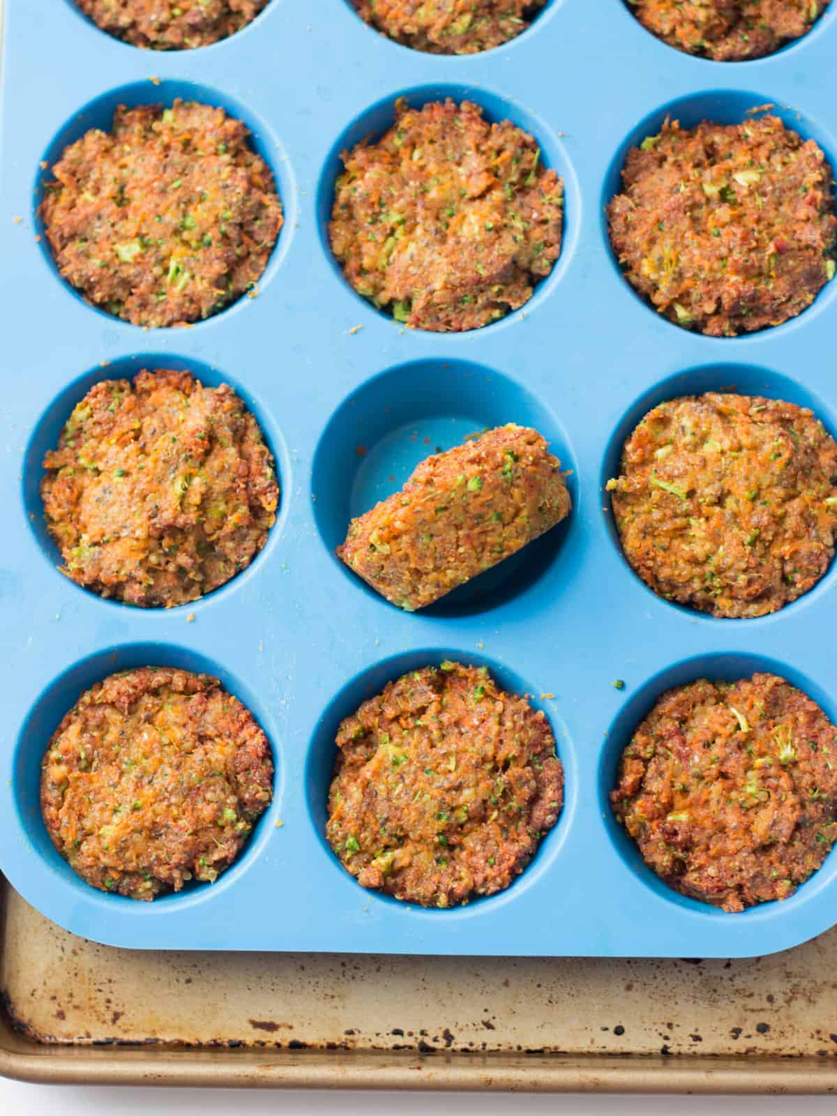 cooked vegetable muffins in blue silicone muffin pan