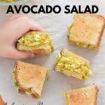 curry chicken avocado salad sliced into 5 small pieces with toddler's hand grabbing one