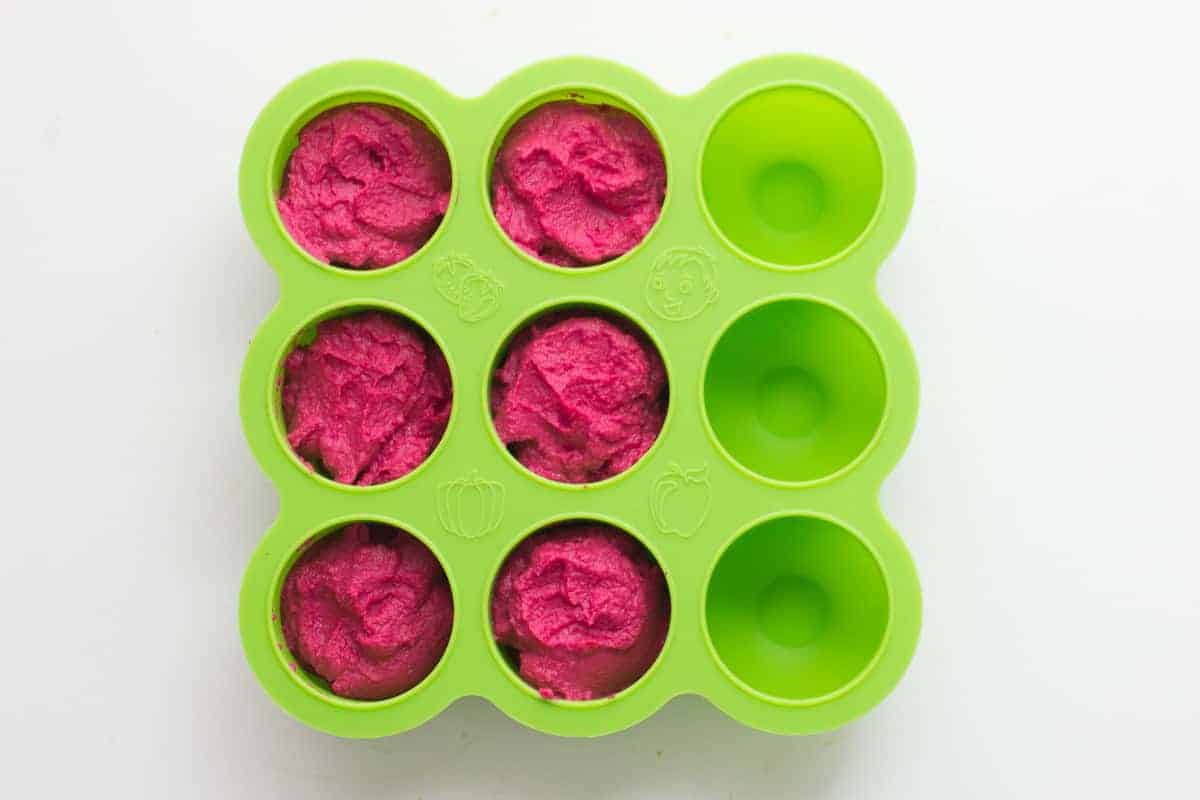 beet hummus spooned into a silicone freezer tray