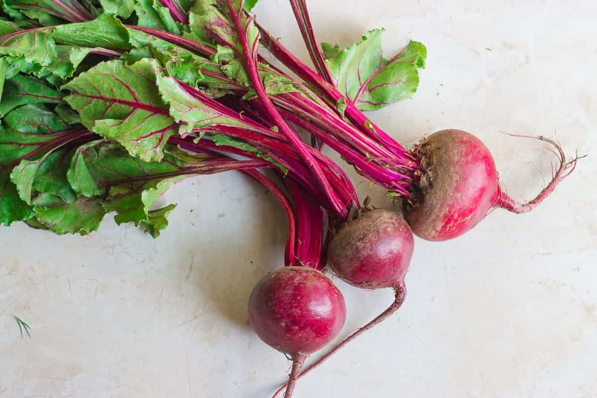 three beetroots attached to the greens.
