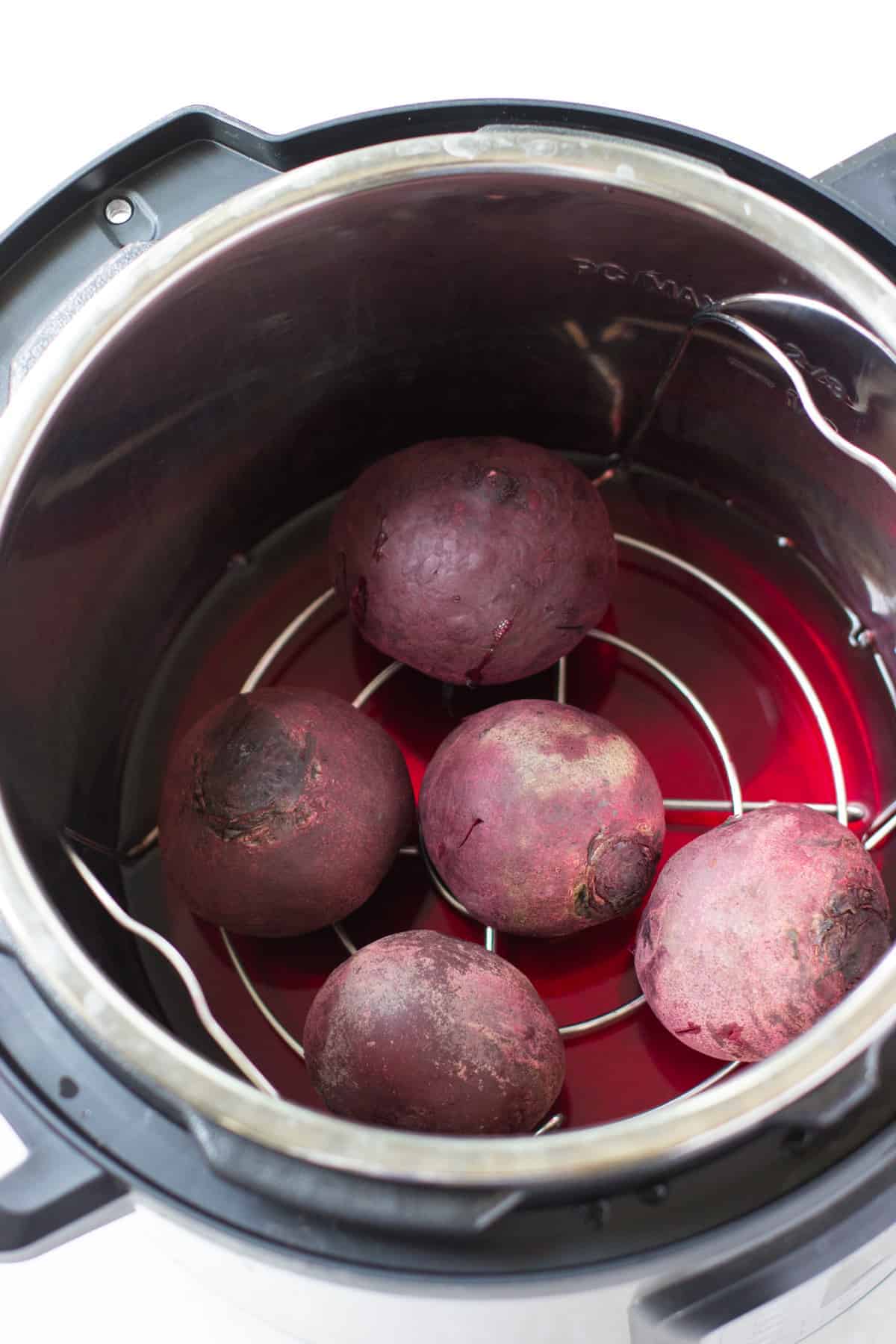five beetroots cooked in an Instant Pot.