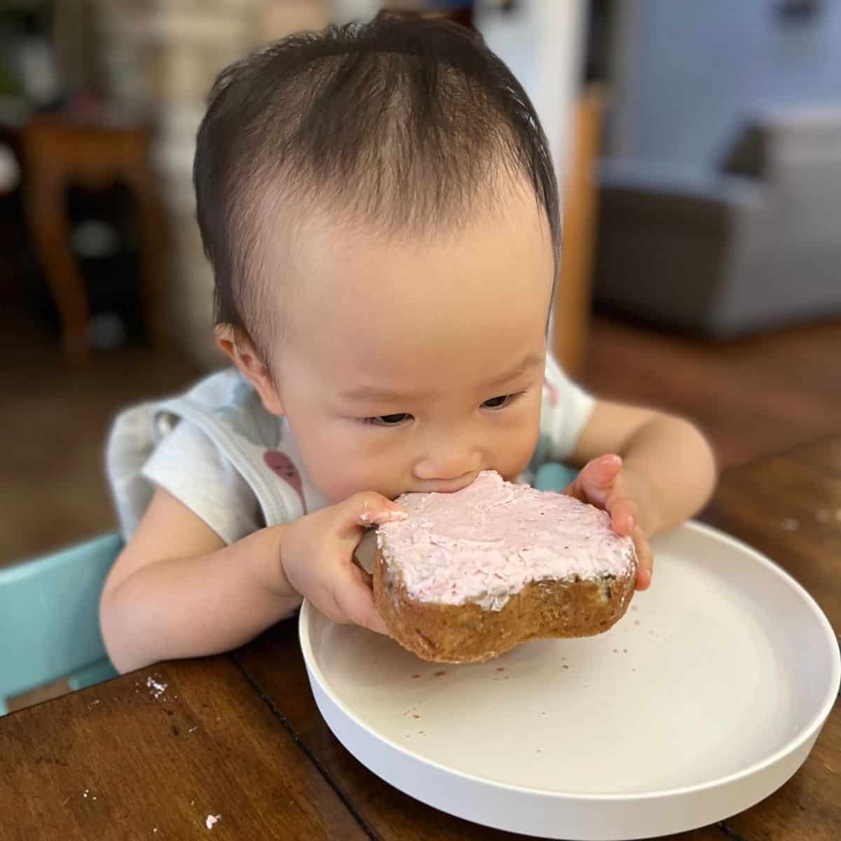 baby biting into a whole layer of cake.