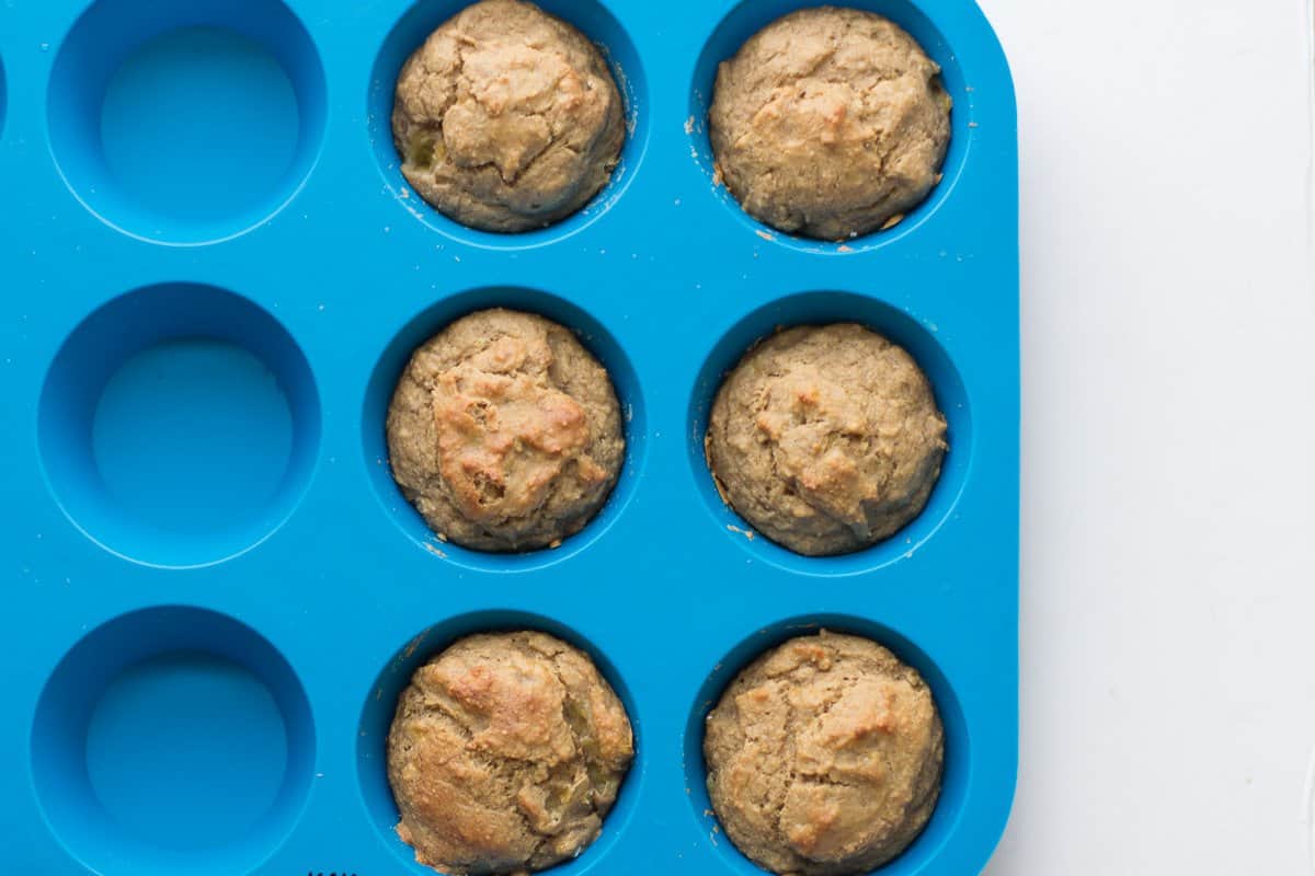 six muffins in a blue silicone muffin pan.