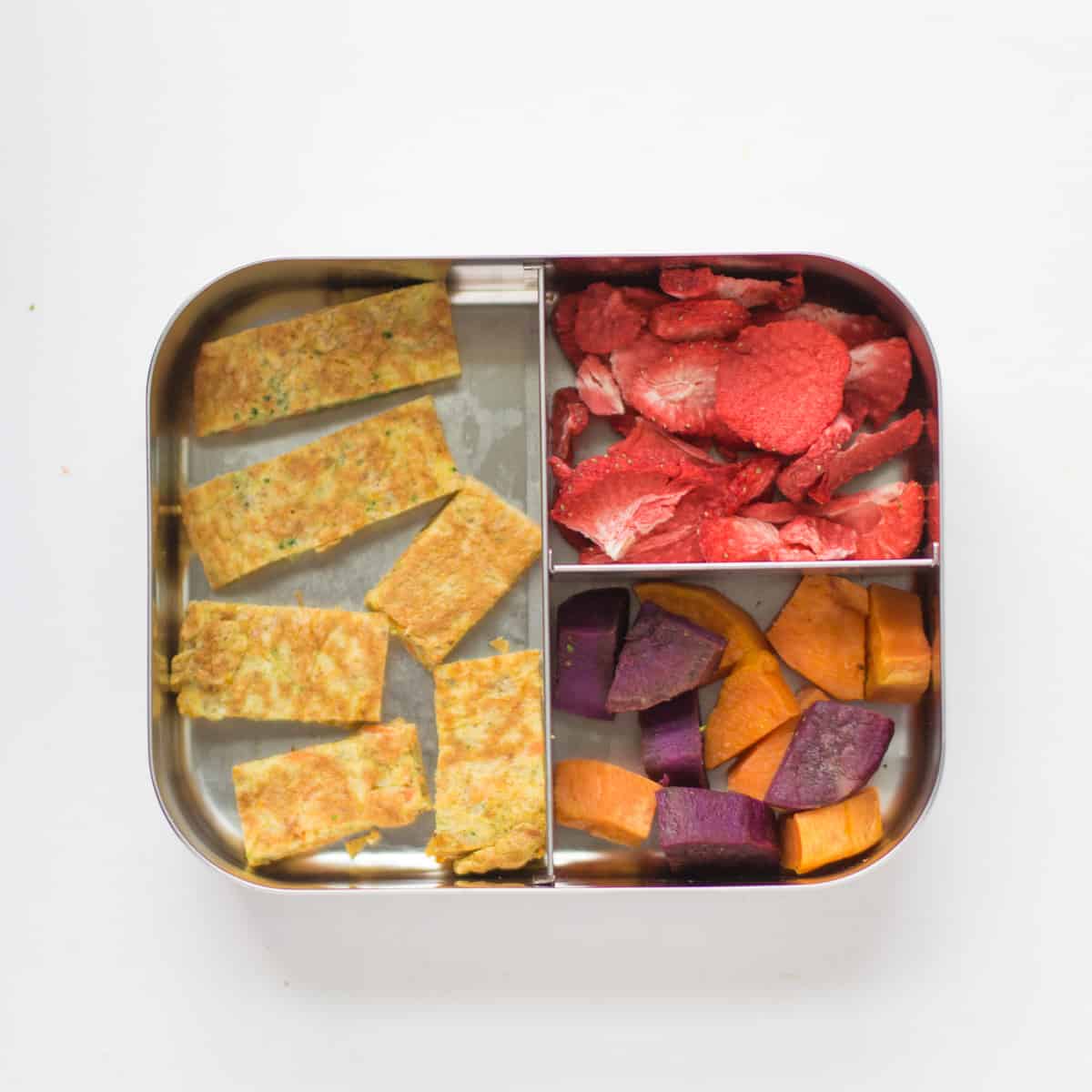 Vegetable omelette strips, freeze dried strawberries, and orange and purple sweet potatoes.