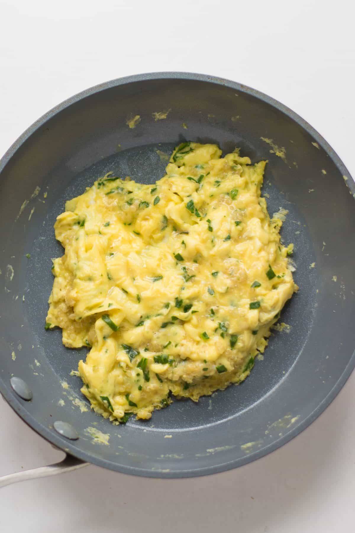 quinoa spinach scrambled eggs in a nonstick pan.