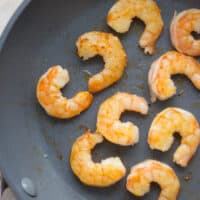 Sauteed shrimps in a skillet.