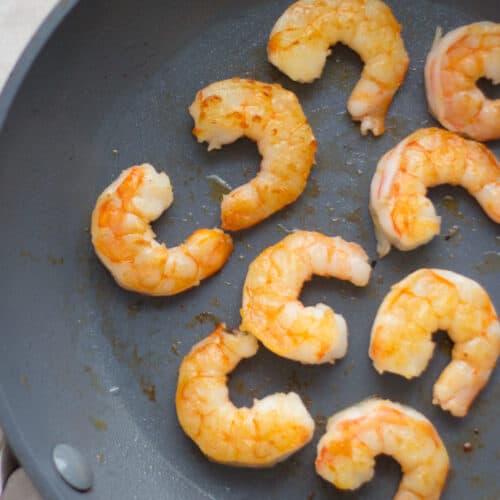 Sauteed shrimps in a skillet.