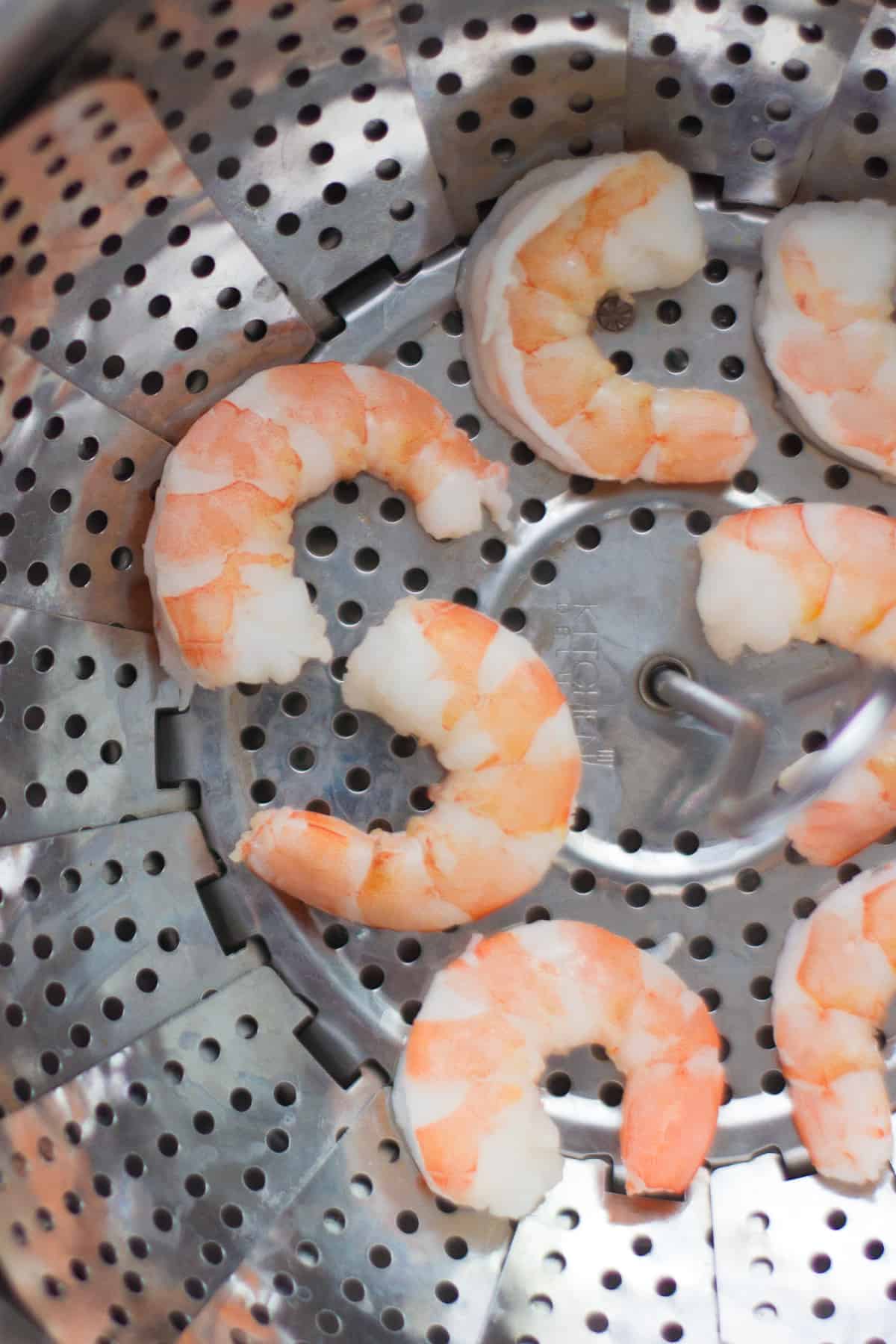 Steamed shrimps in a steamer basket.