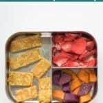 a lunchbox with omelette strips, freeze dried strawberries, roasted orange and purple sweet potatoes.