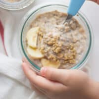 overnight oats with sliced banana, ground walnuts in a bowl.