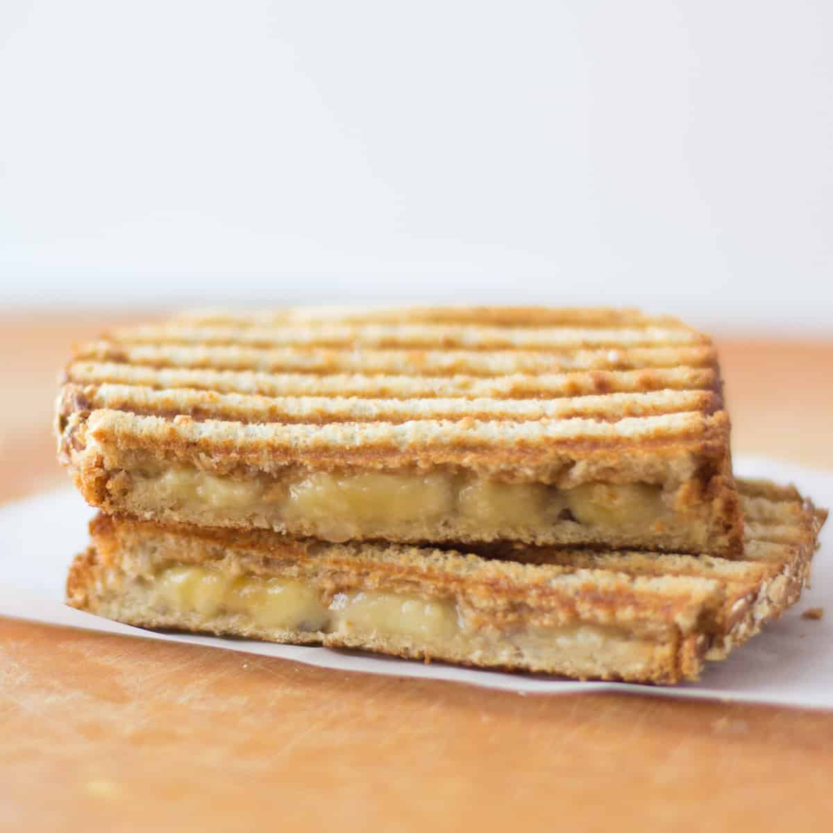 Two peanut butter banana sandwich halves stacked.