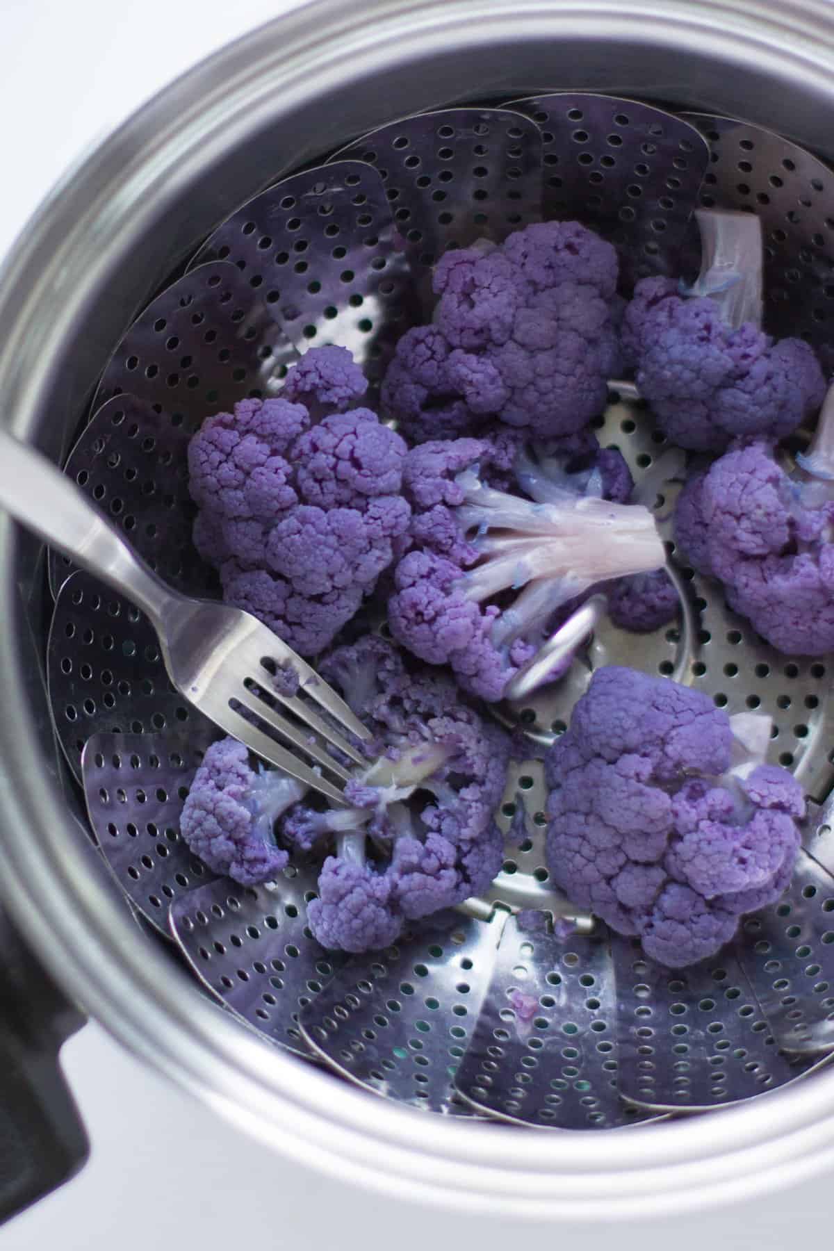A close up shot of steamed purple cauliflower.
