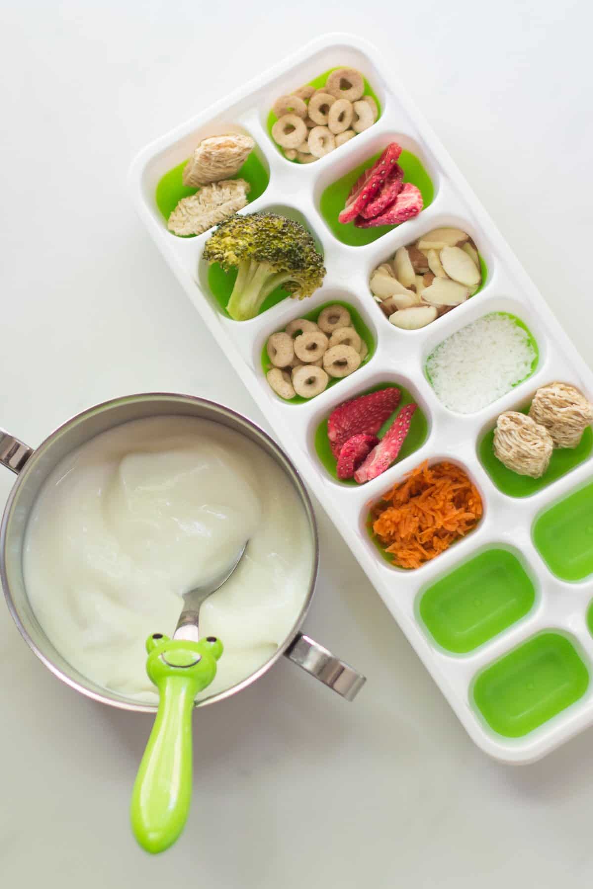 yogurt with an assortment of toppings in ice cube tray.