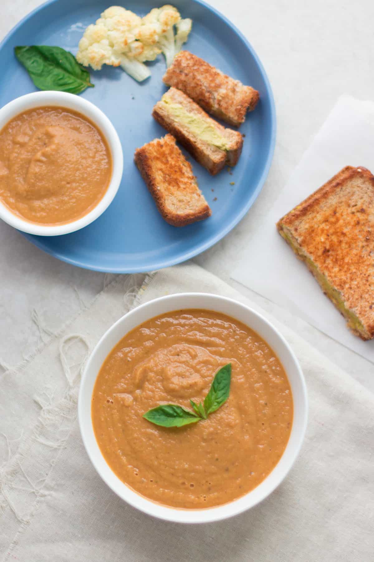 Soup served with grilled cheese sandwich.