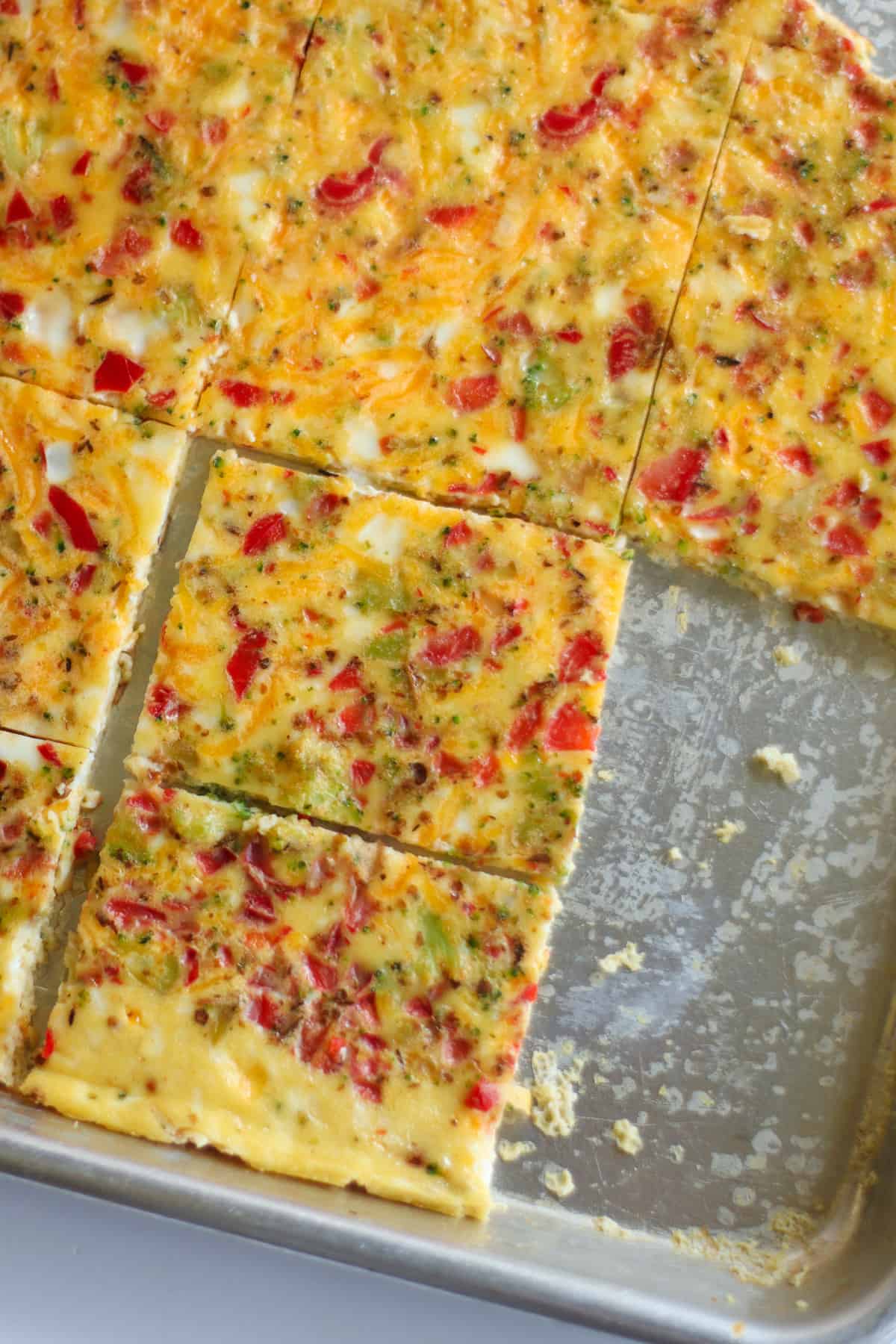 A close up shot of baked sheet pan eggs with slices taken  out.