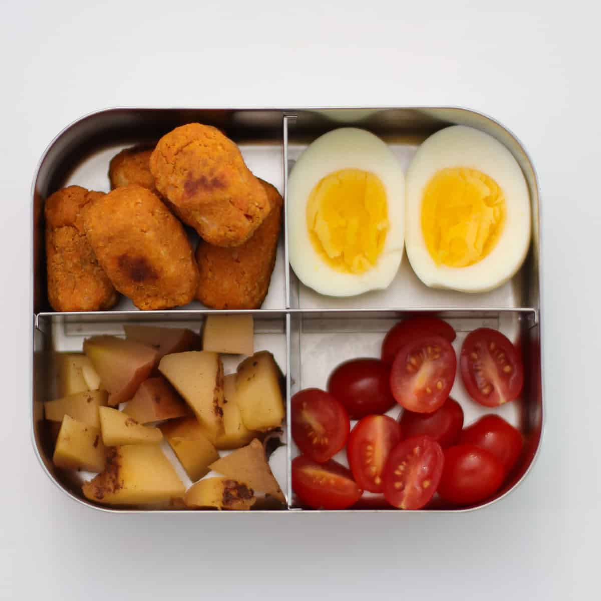 Sweet potato tots with hardboiled eggs, peaches, tomatoes.