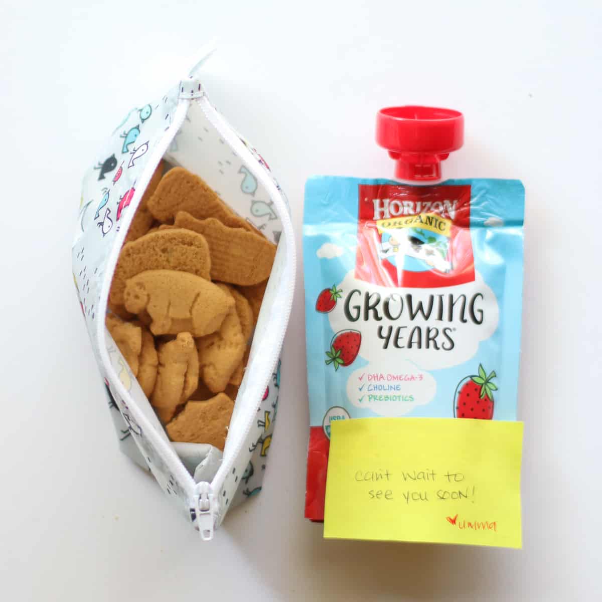 Animal crackers in a reusable bag with a yogurt pouch.