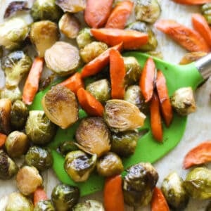A close up shot of roasted brussels sprouts and carrots.