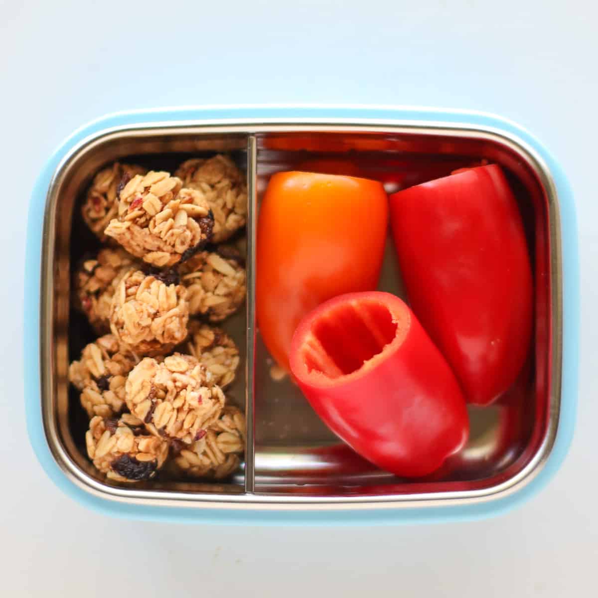 Mini granola bites with 3 mini bell peppers with seeds removed.