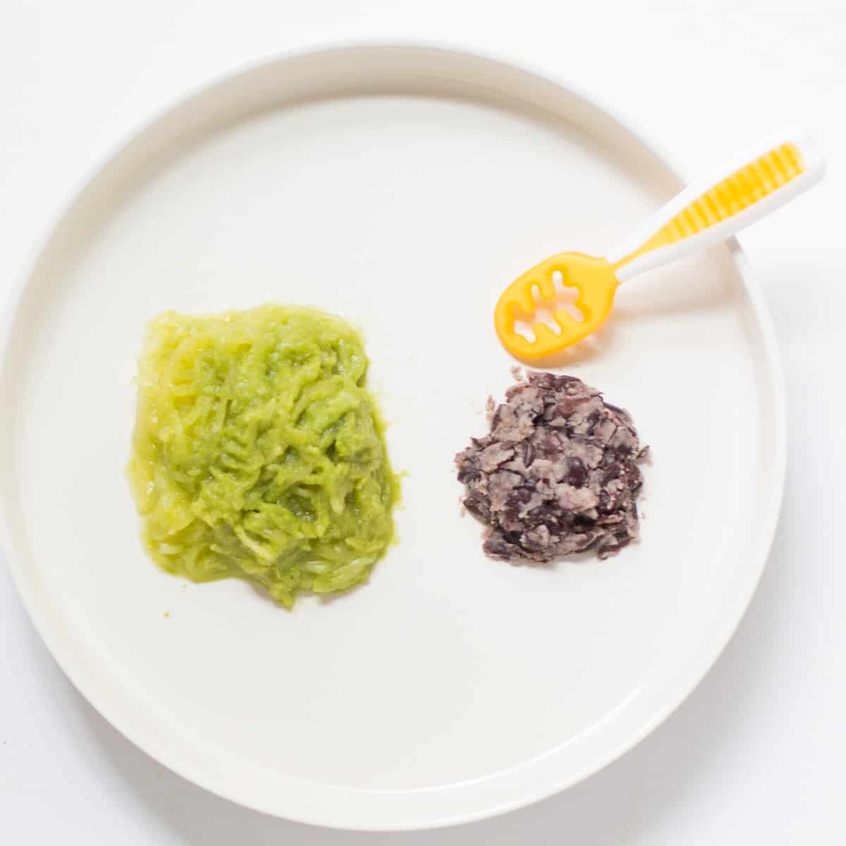 Cooked spaghetti squash tossed with pesto with mashed black beans.