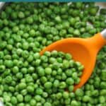 Sauteed frozen peas in a large skillet.