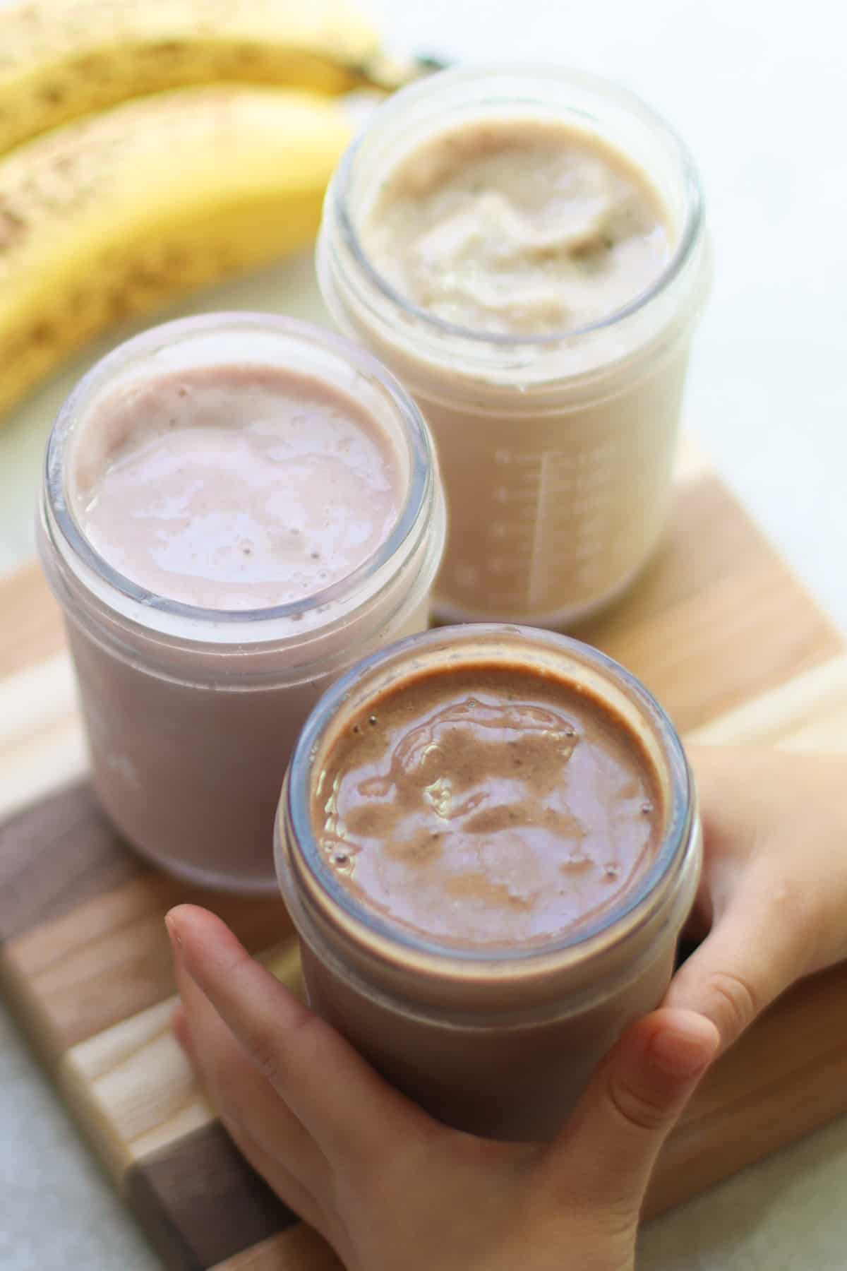 A close up shot of the milkshakes in  glass jars.