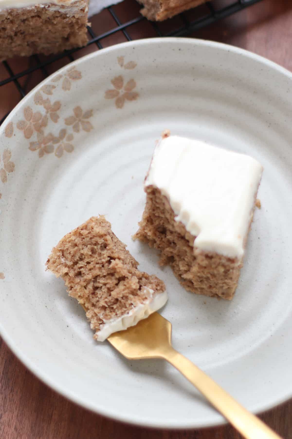 An overhead shot of banana walnut cake with a piece taken out and on a fork.