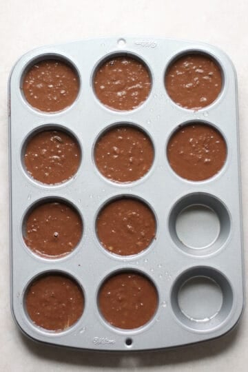 Batter transferred to a muffin pan.
