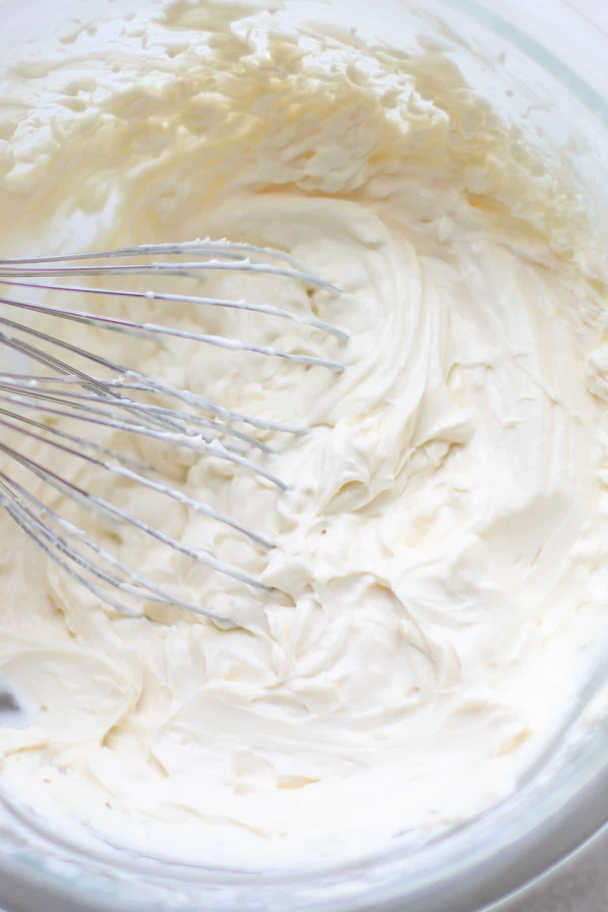 Whipped cream cheese frosting with hand mixer.