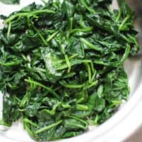 Sauteed spinach in a skillet.