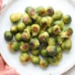 Browned roasted frozen Brussels sprouts piled on a plate.