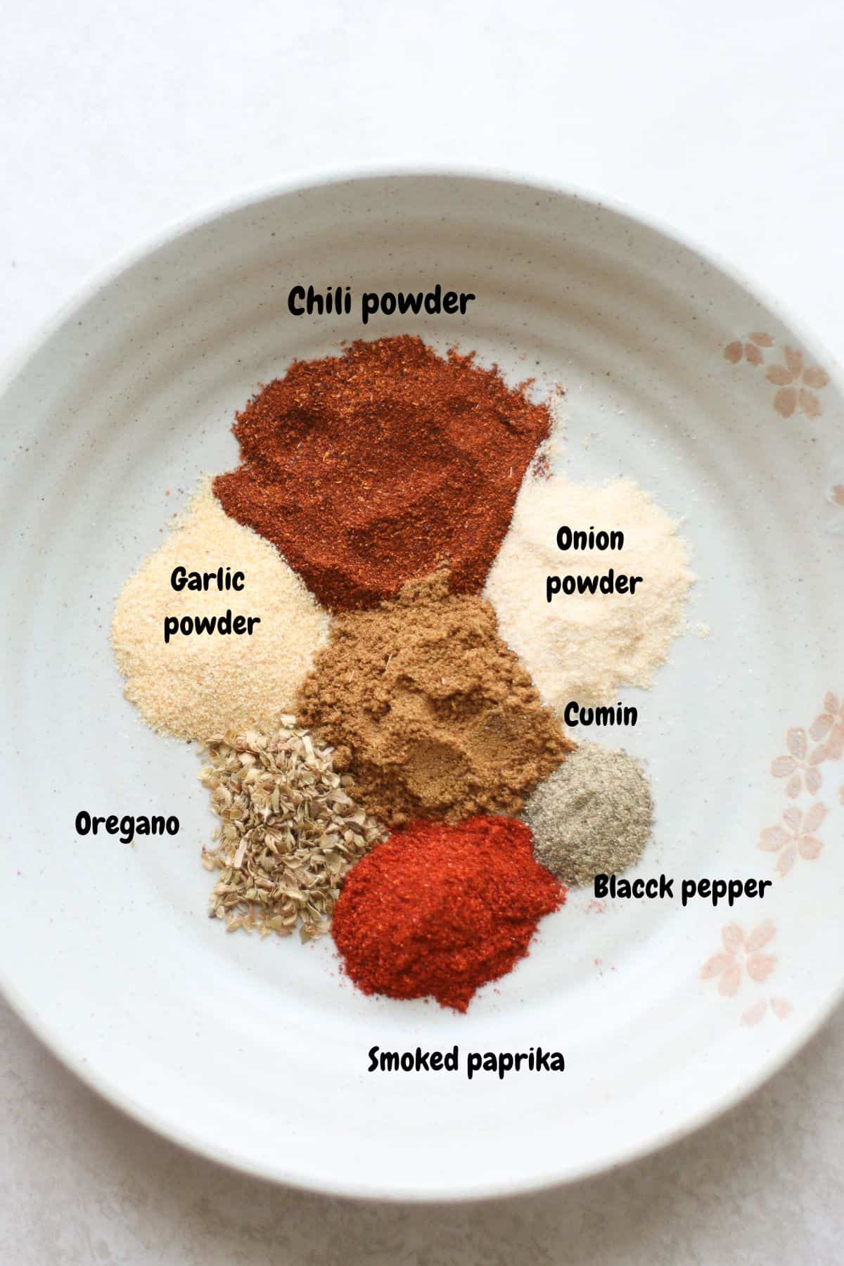 All the spices laid out on a large bowl.