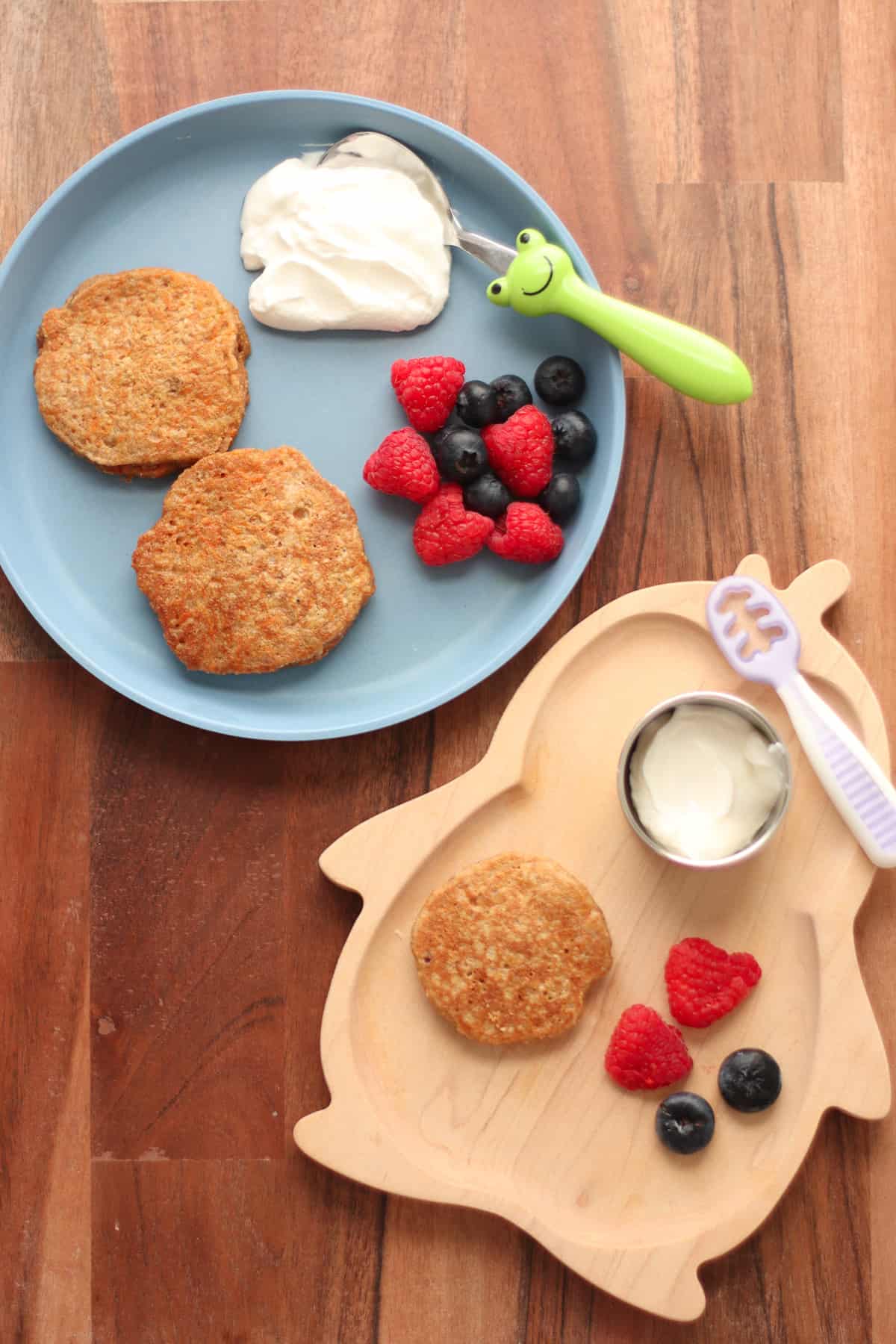 A toddler and baby's plate with carrot pancakes, berries, yogurt.