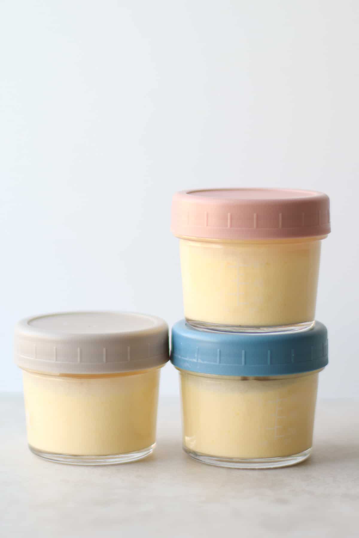 Mango yogurt stored in three glass containers.